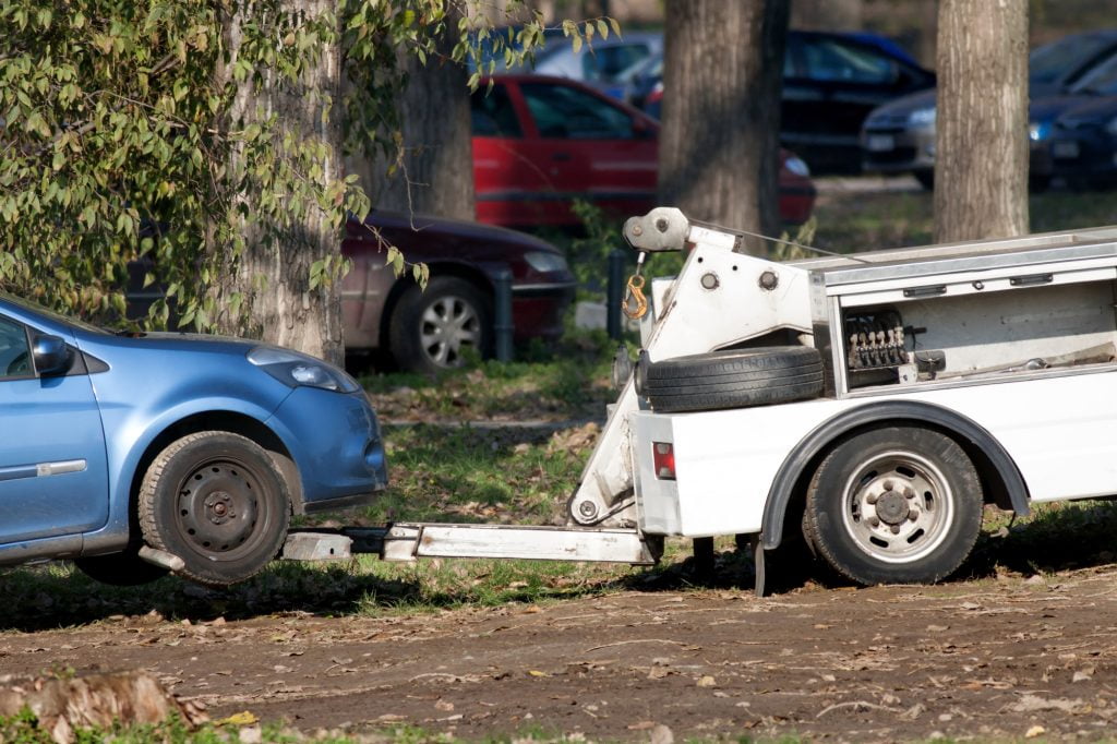 Truck Towing Car Parked Wrongly Off Parking Lot