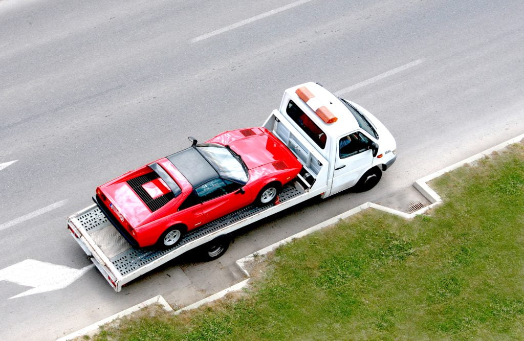 Fast Oldtimer Car On The Carrier Vehicle